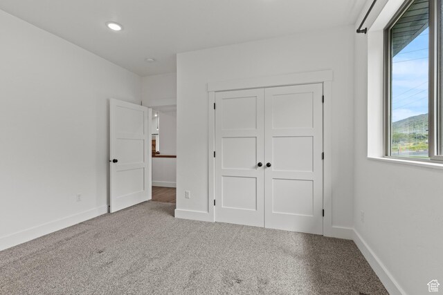 1885 N 2000 E, North Logan, UT 84341 - unfurnished bedroom featuring multiple windows, baseboards, a closet, carpet floors, and recessed lighting