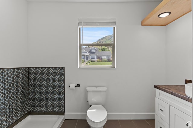 1885 N 2000 E, North Logan, UT 84341 - full bathroom with baseboards, vanity, tile patterned floors, tiled shower, and toilet
