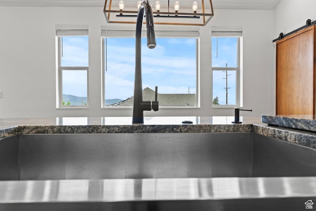 1885 N 2000 E, North Logan, UT 84341 - kitchen view of dark stone counters, a barn door, and a sink