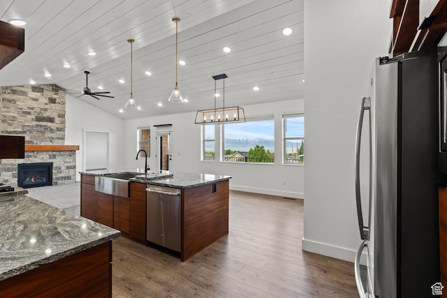 1885 N 2000 E, North Logan, UT 84341 - kitchen with appliances with stainless steel finishes, a sink, a fireplace, a ceiling fan, and open floor plan