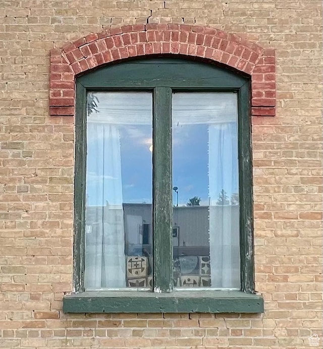 doorway to property featuring brick siding