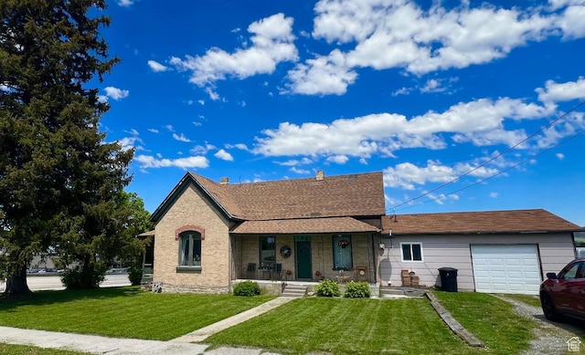 view of front of house with an attached garage, a front lawn, covered porch, and driveway
