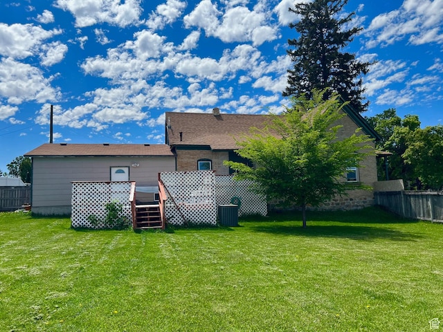 rear view of house featuring a wooden deck and central AC