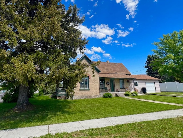 view of front facade with a porch, a garage, brick siding, and driveway
