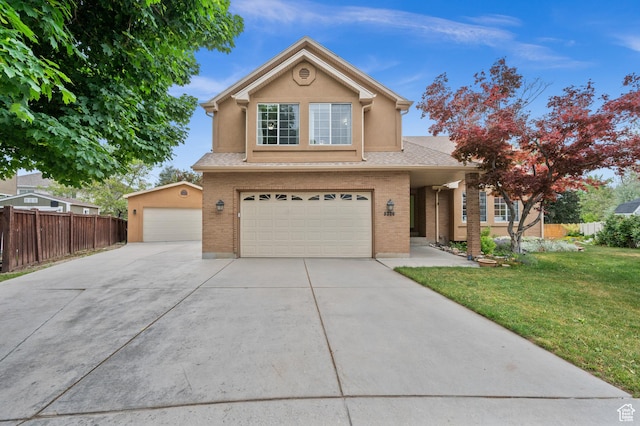 traditional-style home with an attached garage, a shingled roof, brick siding, stucco siding, and driveway