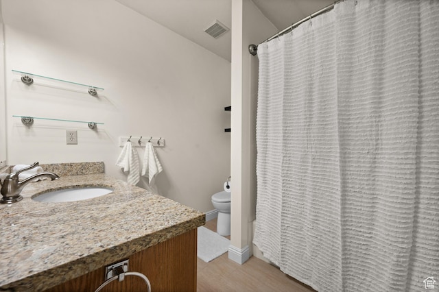 full bath with toilet and vanity