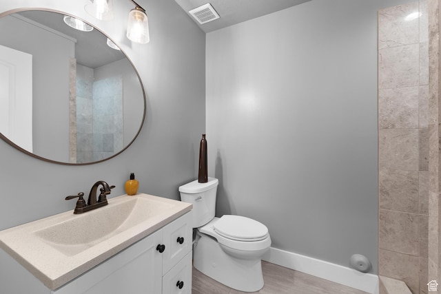 5982 N Rollins Ranch Rd W, Mountain Green, UT 84050 - full bathroom featuring wood finished floors, toilet, vanity, and baseboards