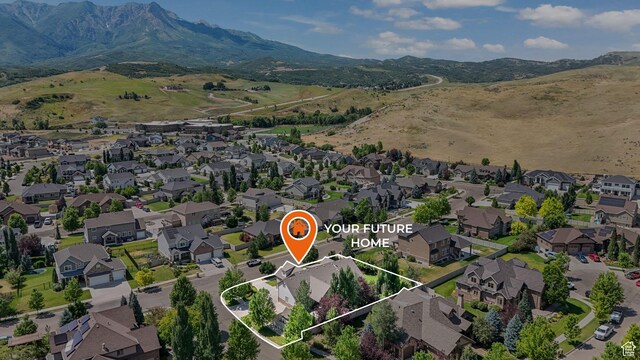 5982 N Rollins Ranch Rd W, Mountain Green, UT 84050 - aerial perspective of suburban area with property parcel outlined and mountains
