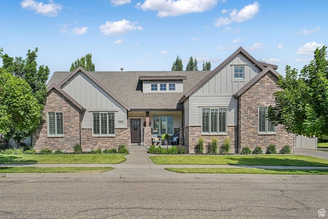 5982 N Rollins Ranch Rd W, Mountain Green, UT 84050 - craftsman inspired home featuring board and batten siding, stone siding, roof with shingles, and a front yard