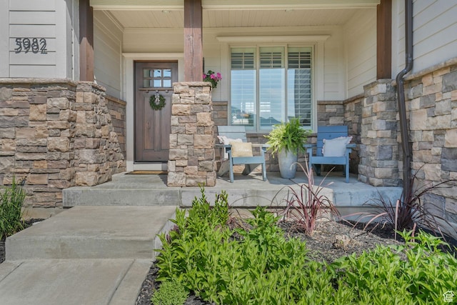 5982 N Rollins Ranch Rd W, Mountain Green, UT 84050 - doorway to property featuring stone siding and a porch