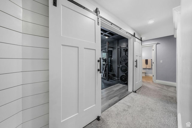 5982 N Rollins Ranch Rd W, Mountain Green, UT 84050 - corridor with a barn door and carpet flooring
