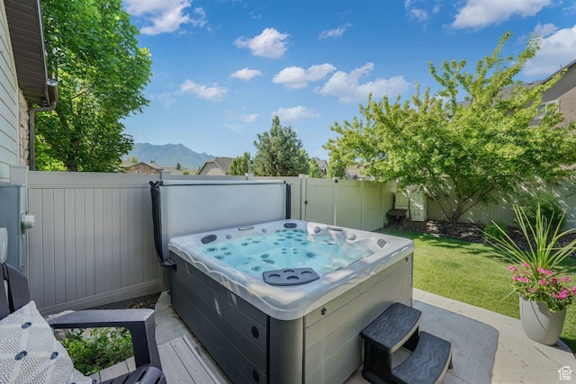 5982 N Rollins Ranch Rd W, Mountain Green, UT 84050 - fenced backyard featuring a hot tub and a mountain view