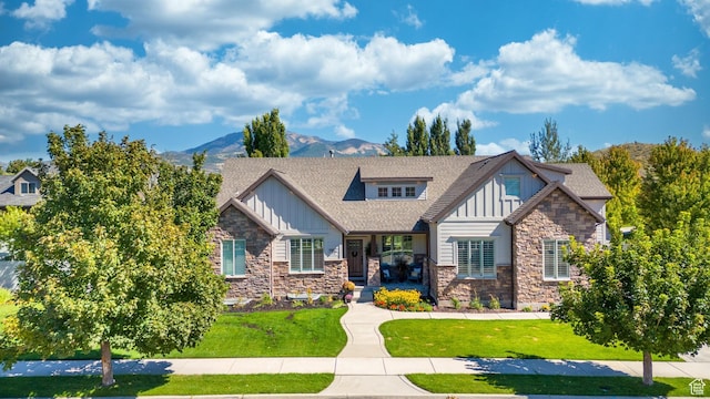 5982 N Rollins Ranch Rd W, Mountain Green, UT 84050 - view of front of house featuring board and batten siding, stone siding, and a mountain view