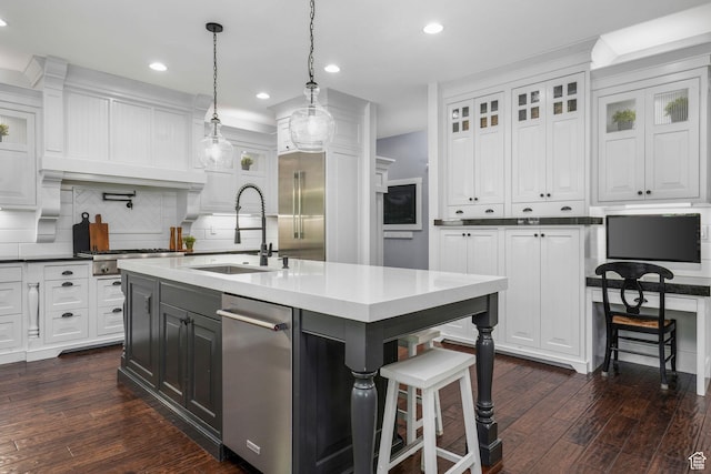 5982 N Rollins Ranch Rd W, Mountain Green, UT 84050 - kitchen featuring white cabinets, decorative backsplash, dark wood-style flooring, appliances with stainless steel finishes, and a kitchen bar