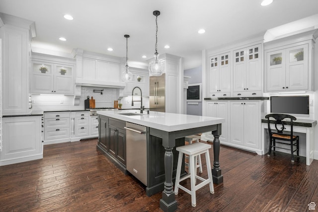 5982 N Rollins Ranch Rd W, Mountain Green, UT 84050 - kitchen with stainless steel dishwasher, white cabinets, a breakfast bar area, and recessed lighting