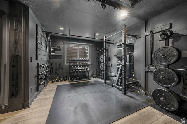 5982 N Rollins Ranch Rd W, Mountain Green, UT 84050 - exercise area featuring wood finished floors and a textured ceiling