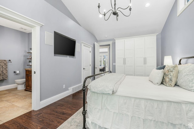 5982 N Rollins Ranch Rd W, Mountain Green, UT 84050 - bedroom featuring vaulted ceiling, a chandelier, ensuite bath, and wood finished floors