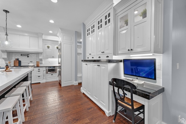 5982 N Rollins Ranch Rd W, Mountain Green, UT 84050 - kitchen with white cabinetry, tasteful backsplash, dark wood finished floors, recessed lighting, and glass insert cabinets
