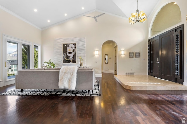 entrance foyer featuring wood-type flooring, arched walkways, high vaulted ceiling, a chandelier, and crown molding
