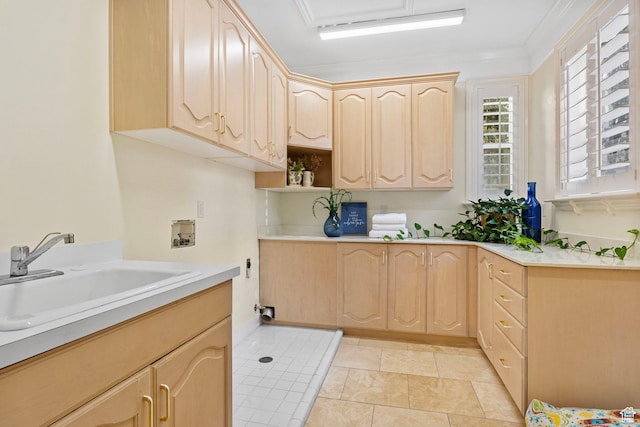 kitchen with light brown cabinetry, a sink, light countertops, and open shelves