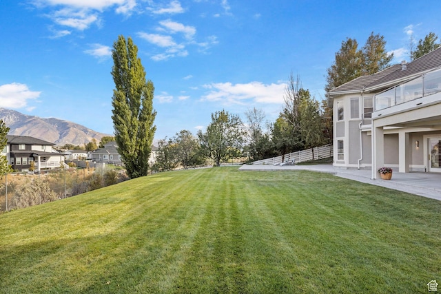 view of yard with a mountain view and a patio