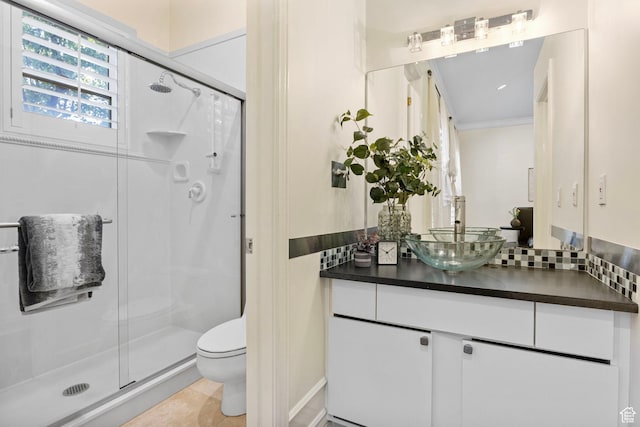 full bath with a stall shower, toilet, ornamental molding, and vanity