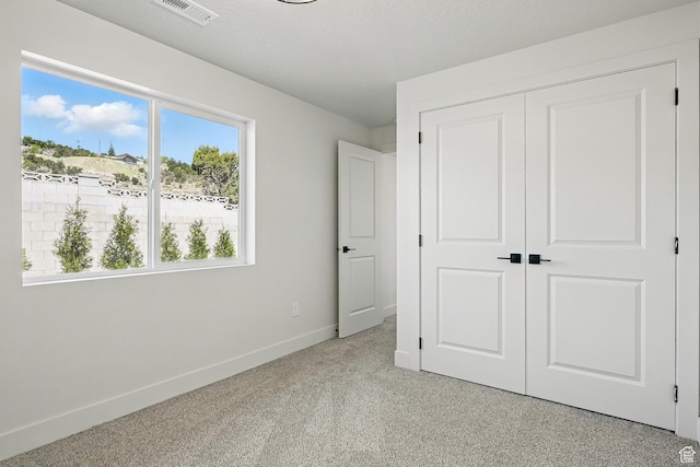 732 S Liberty Dr S, Cedar City, UT 84720 - unfurnished bedroom with baseboards, a closet, and light colored carpet