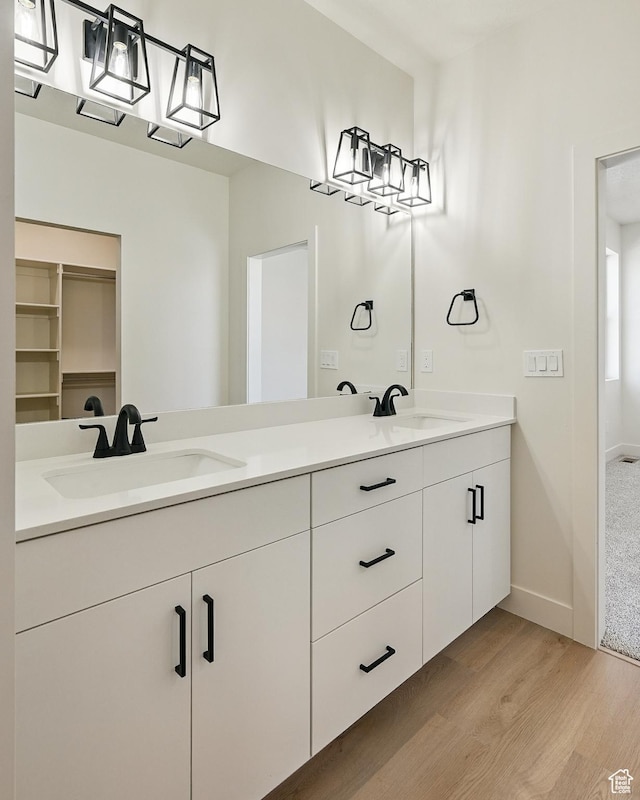 732 S Liberty Dr S, Cedar City, UT 84720 - bathroom featuring wood finished floors, double vanity, and baseboards
