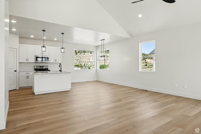 732 S Liberty Dr S, Cedar City, UT 84720 - kitchen with stainless steel appliances, light wood-type flooring, white cabinetry, recessed lighting, and open floor plan