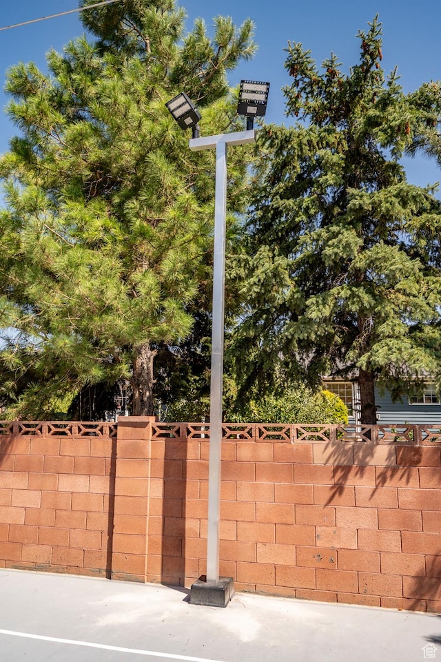 view of basketball court with fence