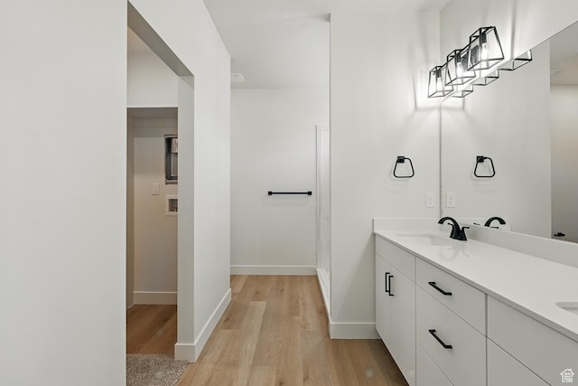 732 S Liberty Dr S, Cedar City, UT 84720 - bathroom featuring wood finished floors, double vanity, and baseboards