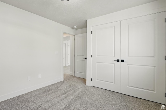 732 S Liberty Dr S, Cedar City, UT 84720 - unfurnished bedroom featuring baseboards, a closet, a textured ceiling, and light colored carpet
