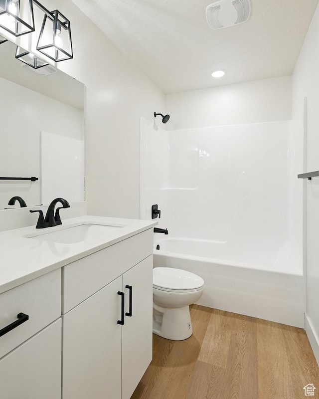 732 S Liberty Dr S, Cedar City, UT 84720 - bathroom with wood finished floors, vanity, toilet, and tub / shower combination