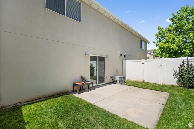 rear view of house featuring a gate, central air condition unit, a patio, and stucco siding