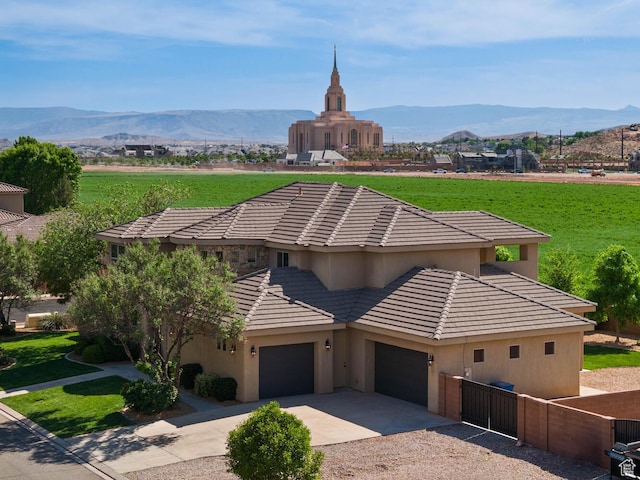 3134 S 355 W, Washington, UT 84780 - view of front of home featuring a tiled roof, a mountain view, driveway, and a garage