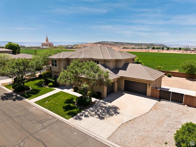 3134 S 355 W, Washington, UT 84780 - view of front of house featuring a garage, driveway, a gate, stucco siding, and a tile roof
