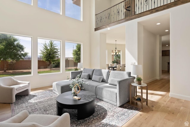 3134 S 355 W, Washington, UT 84780 - living area featuring a towering ceiling, plenty of natural light, a chandelier, light wood-style flooring, and baseboards