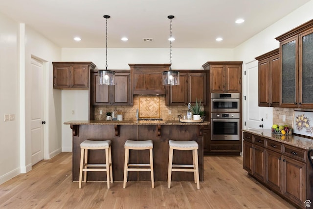 3134 S 355 W, Washington, UT 84780 - kitchen with custom exhaust hood, double oven, backsplash, a kitchen bar, and pendant lighting