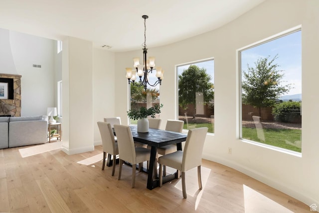 3134 S 355 W, Washington, UT 84780 - dining area with a chandelier, light wood finished floors, baseboards, and a fireplace