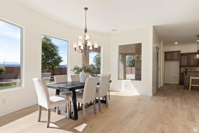 3134 S 355 W, Washington, UT 84780 - dining area featuring a chandelier, healthy amount of natural light, light wood-style floors, and baseboards