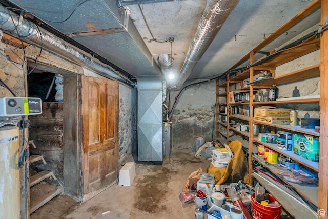 unfinished basement with heating unit and a water softener system