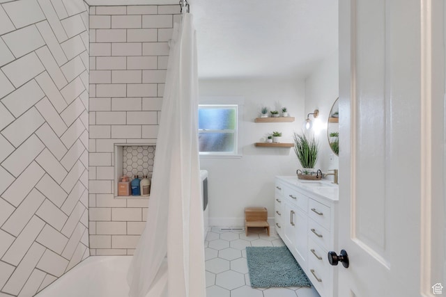 bathroom with tile patterned flooring, vanity, and shower / tub combo
