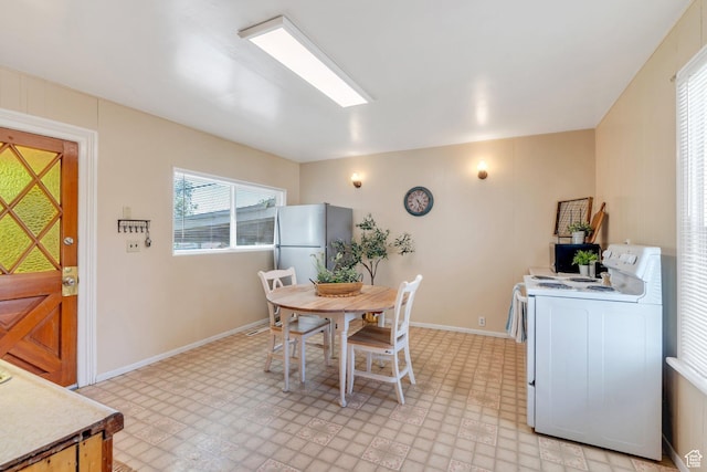 dining area featuring light flooring and baseboards