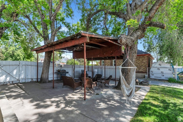 view of patio with fence and a gate