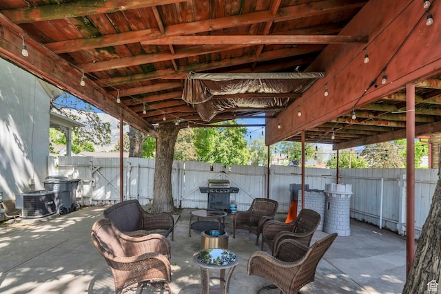 view of patio featuring fence, central AC unit, outdoor lounge area, and area for grilling