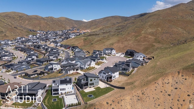 aerial overview of property's location featuring nearby suburban area and mountains