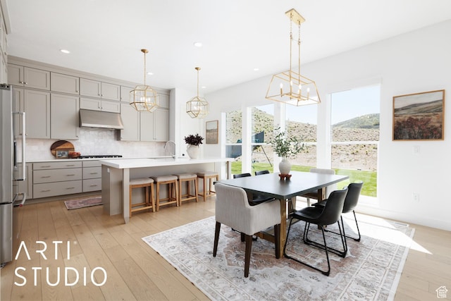 dining room featuring a chandelier, light wood-type flooring, and recessed lighting