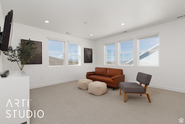 living area with healthy amount of natural light, carpet, baseboards, and recessed lighting