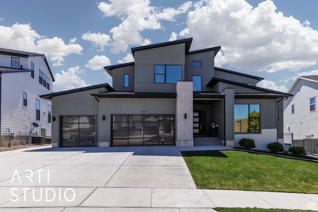 contemporary home with concrete driveway and a garage