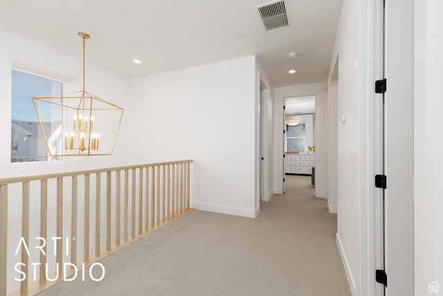 hall featuring carpet, baseboards, a chandelier, and recessed lighting